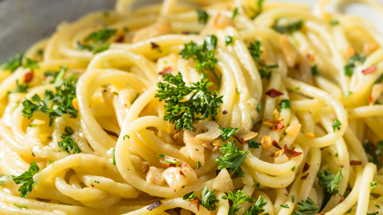 close up of buttered noodles fresh herbs and spices