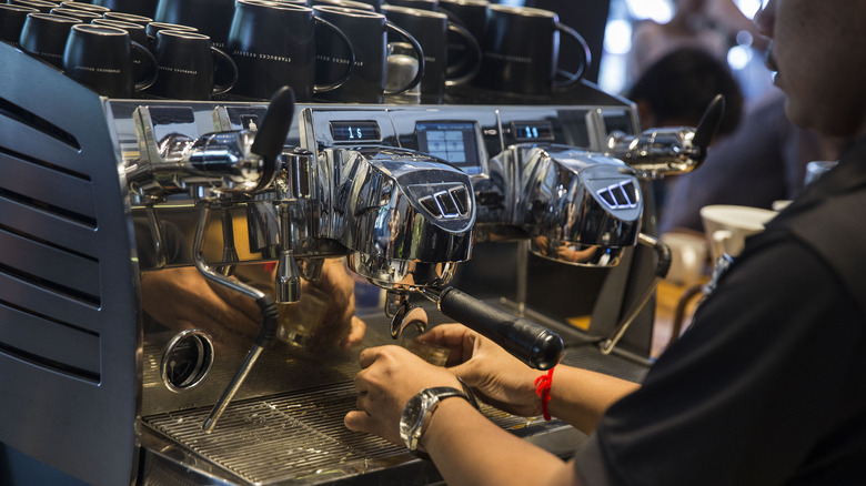 Starbucks barista making espresso with machine