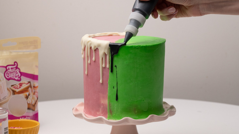 dripping black melt onto cake