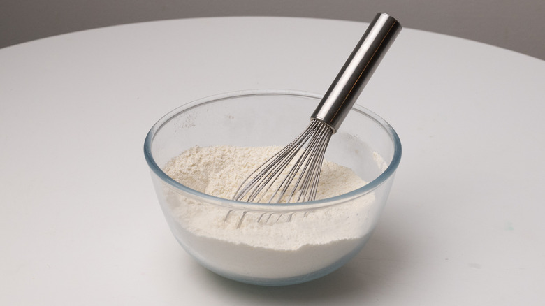 whisking flour in a bowl