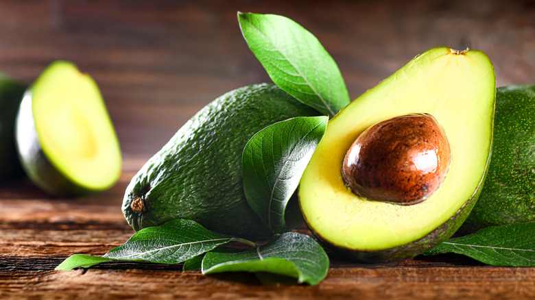 Avocados on wooden table