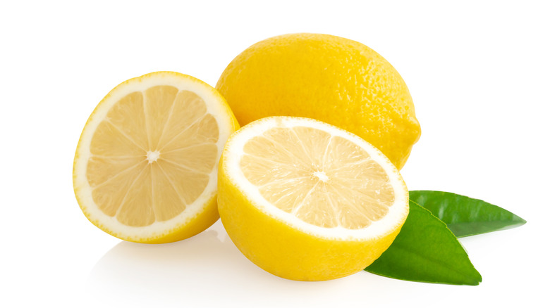 full lemon and lemon split in half