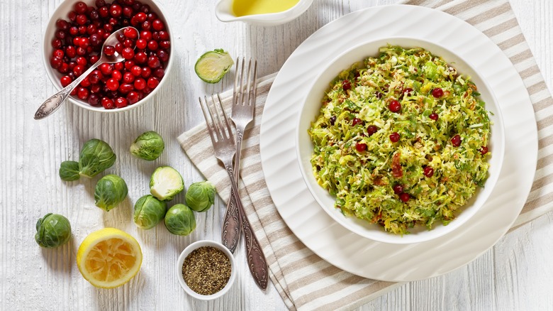 Bowl of Brussels sprouts slaw with cranberries, forks