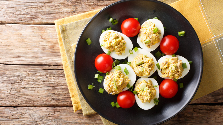 deviled eggs on black plate