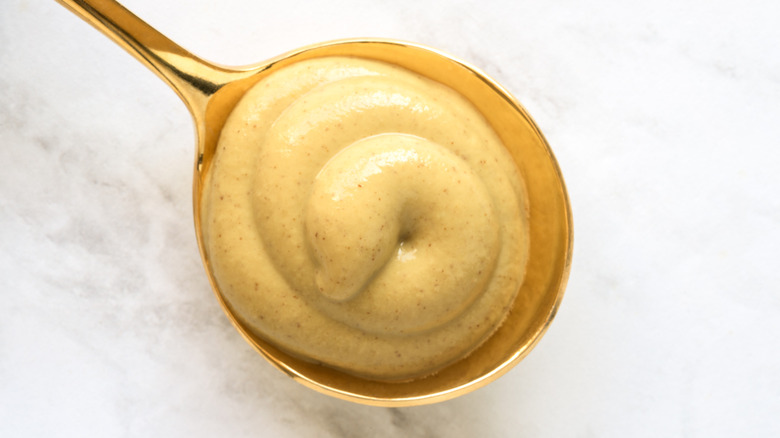 Dijon mustard on a golden spoon