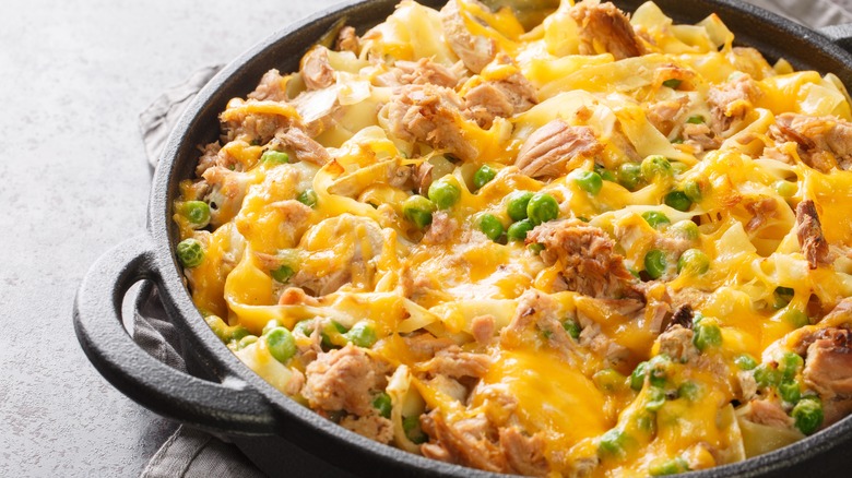 closeup of tuna casserole with peas in cast iron skillet