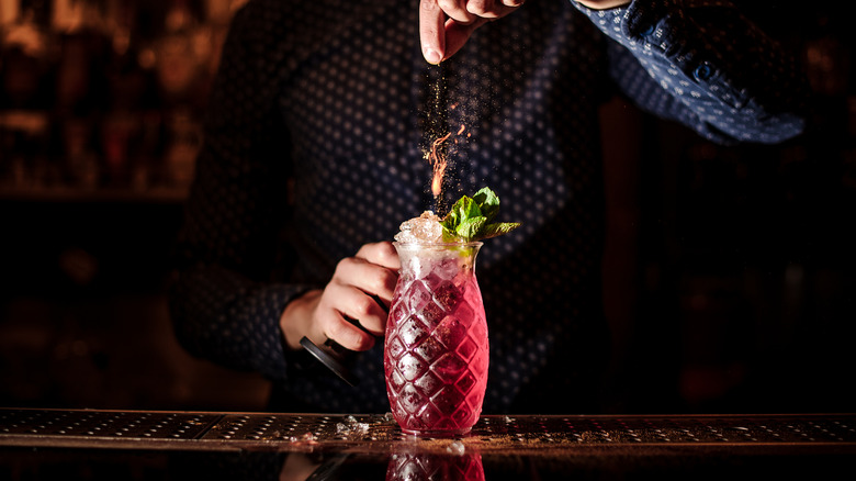 bartender decorating a cocktail