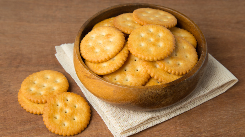 Salted butter crackers in a wooden bowl