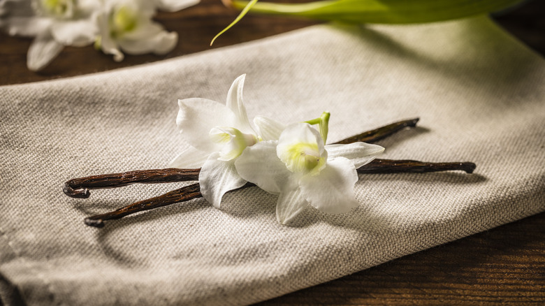 vanilla beans and flowers on cloth