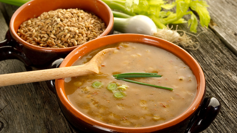 Bowl of soup with farro in background