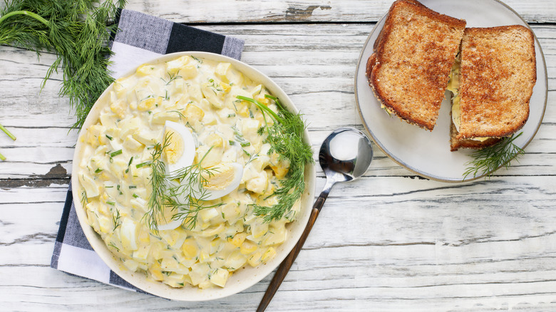 bowl of egg salad and sandwich