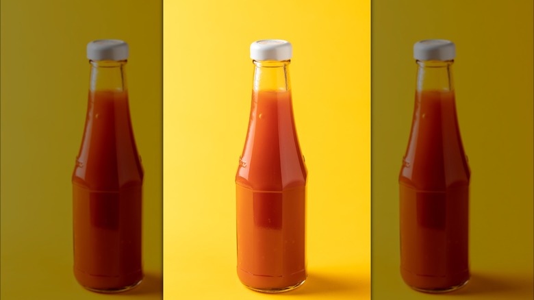 Bottle of homemade hot sauce against a yellow background