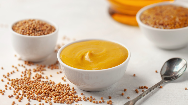 Different types of mustard in bowls