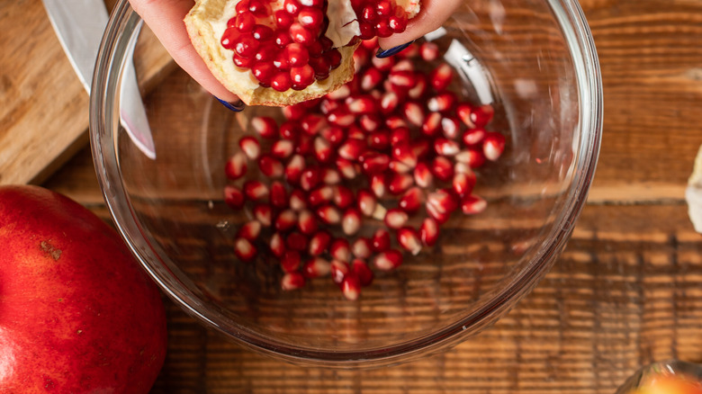 hands holding pomegranate half