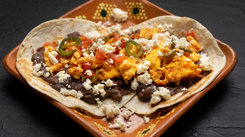 eggs and refried beans over tortillas