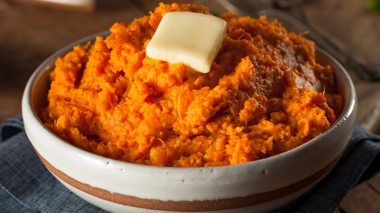 Bowl of mashed sweet potatoes with butter