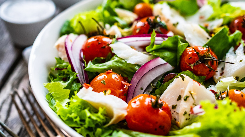 Bowl of salad with forks 