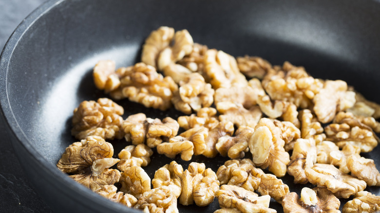 Walnuts toasting in a pan