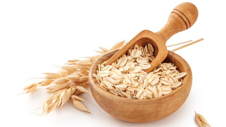 Raw oats in a wooden bowl