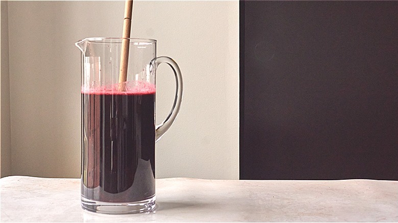 stirring agua fresca in pitcher