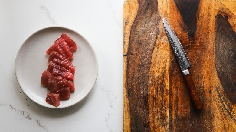 raw fish with knife