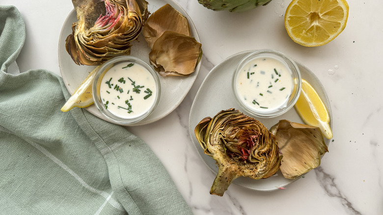 2 plates with artichoke halves