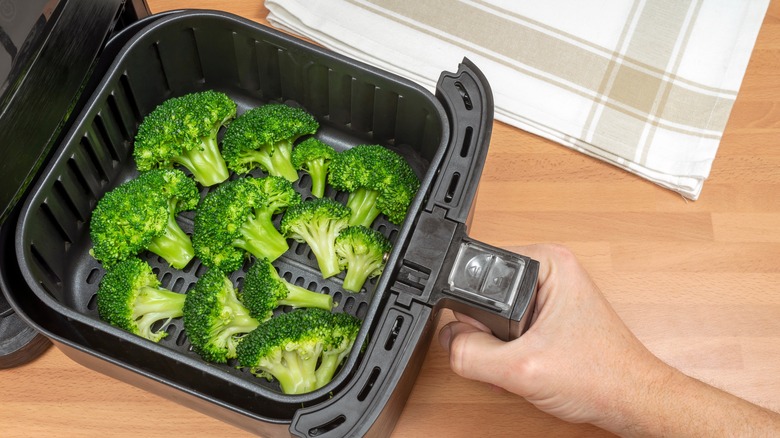 broccoli florets in air fryer basket