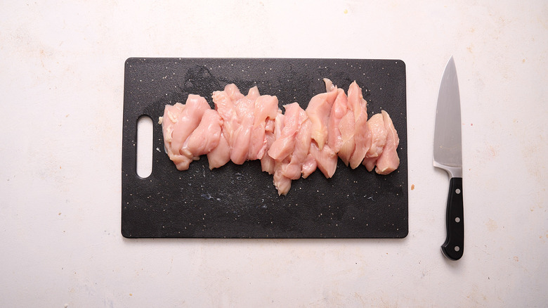 chicken strips on cutting board