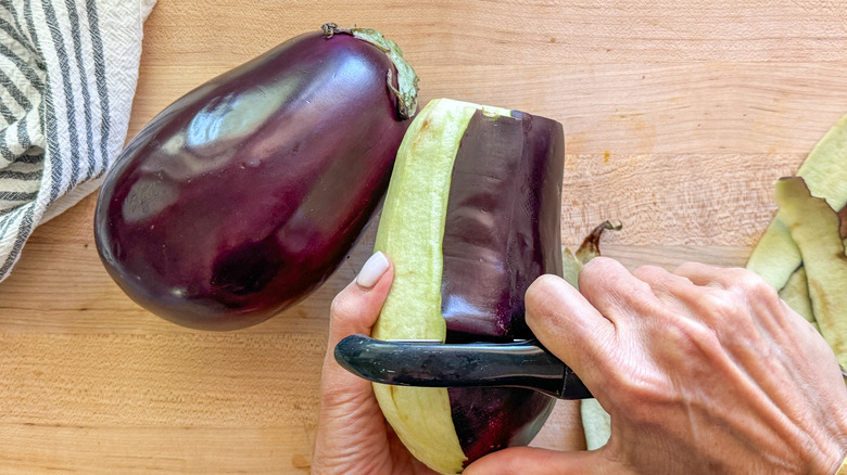 hand peeling eggplant