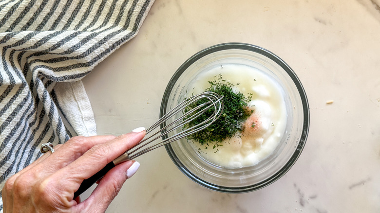 hand stirring dip with whisk