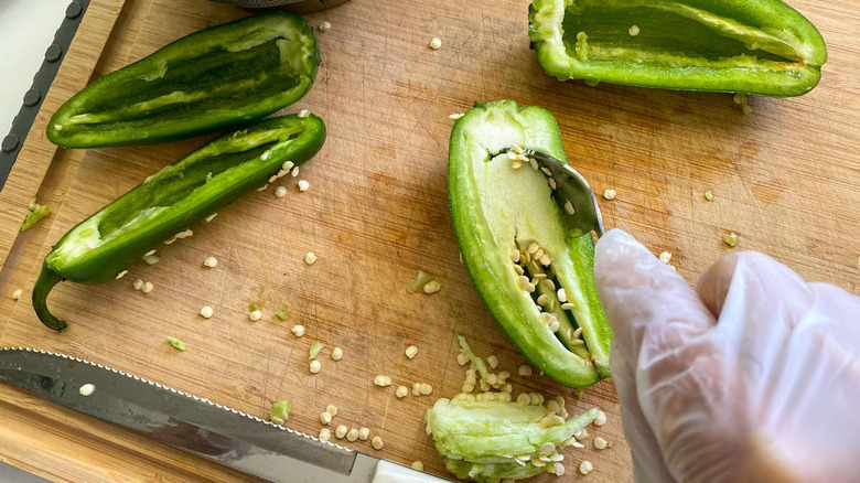 hand removing jalapeno core