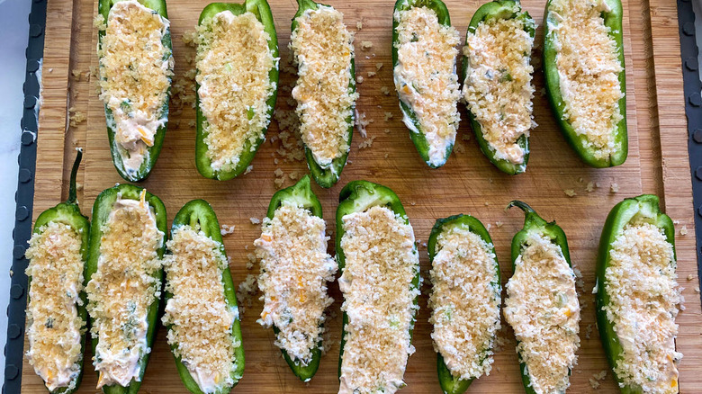 stuffed jalapeno halves on cutting board