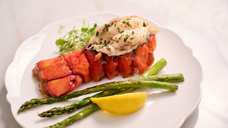 lobster tail on a plate with asparagus