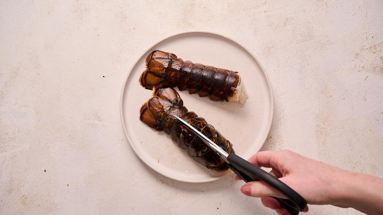 cutting the lobster shell with shears
