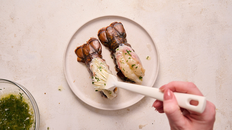 brushing butter onto lobster