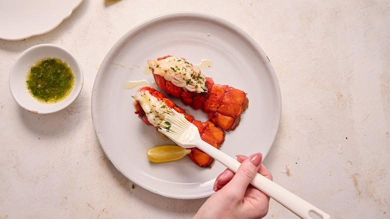 brushing lobster tail with garlic butter