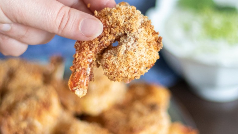 hand holding fried shrimp