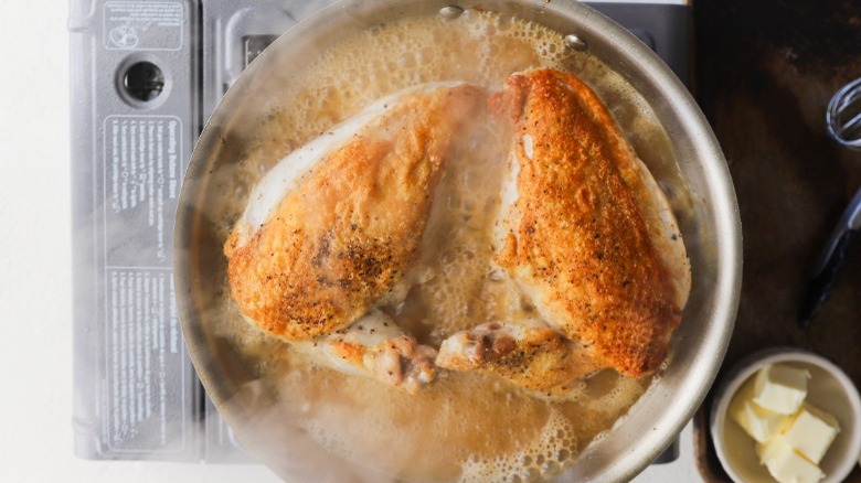 Chicken simmering in broth