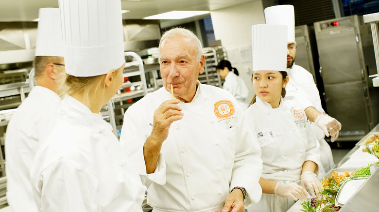 Chef Alain Sailhac in kitchen with chefs