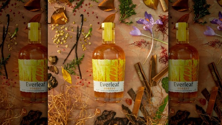 Everleaf "Forest" amber bottle surrounded by botanicals