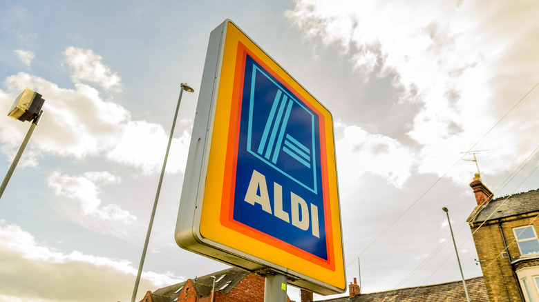 Large Aldi sign against blue sky