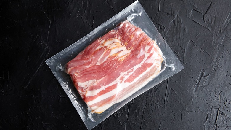 Raw bacon strips in plastic