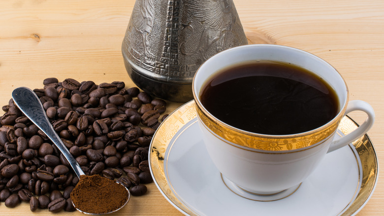 Coffee beans and cup on saucer