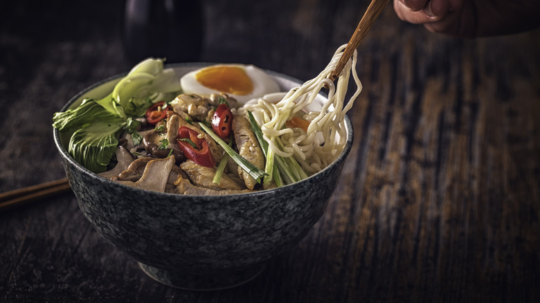 Ramen topped with fresh veggies, meat, and egg