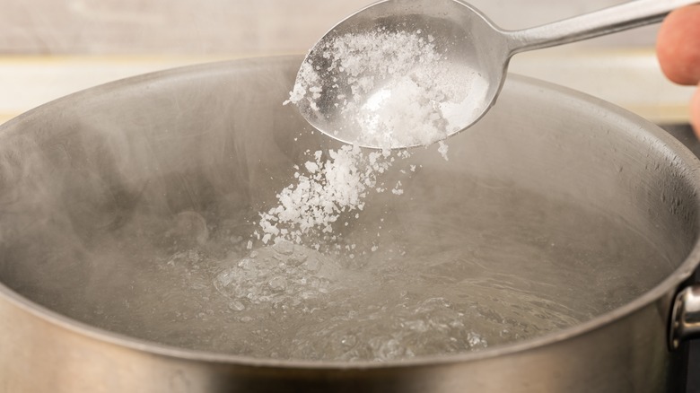 adding salt to boiling water