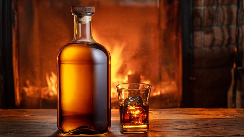 whiskey bottle and glass on wooden table