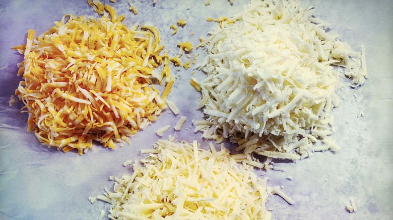 piles of different shredded cheese