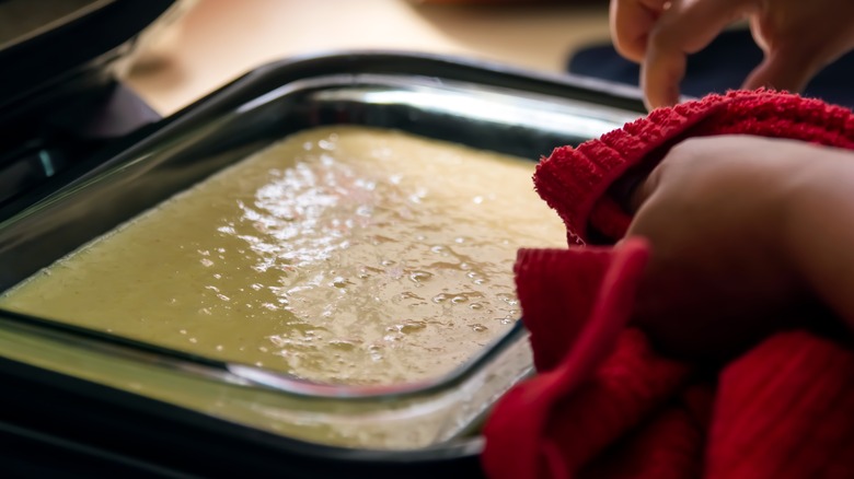 Unbaked cake being put in oven 