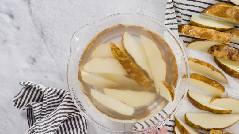 Potato wedges soaking in water