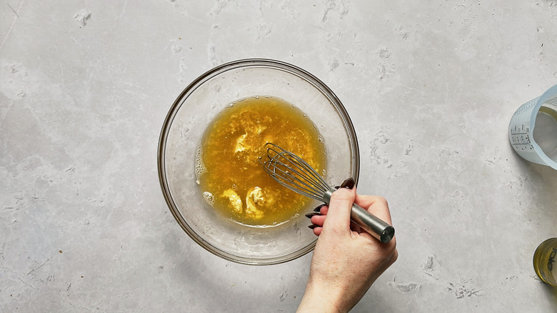 whisking dressing in bowl